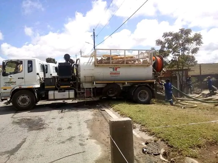 Vacuum tanker desludging a sewer line on a street in Mthatha