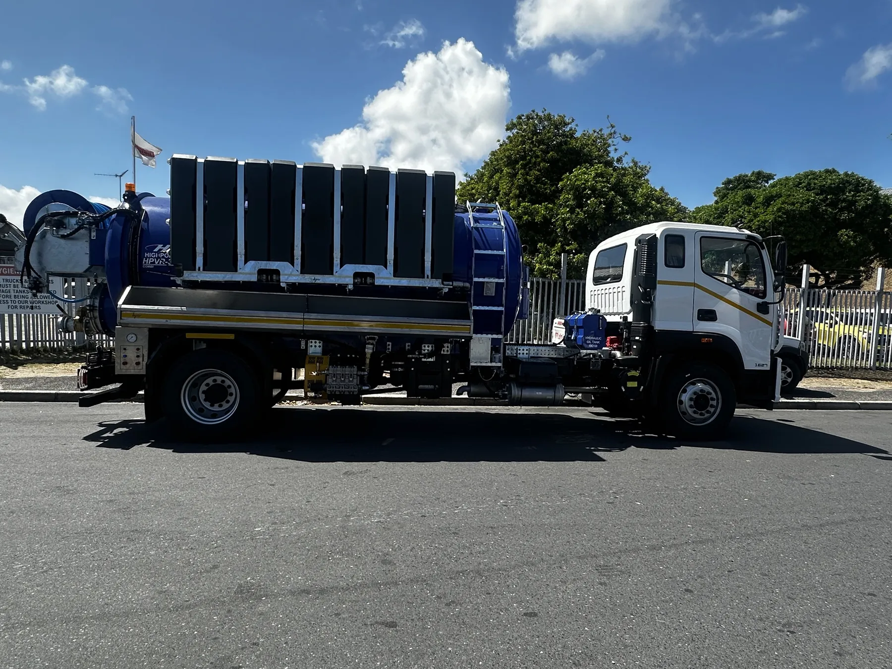 Side view of a blue Highpoint HPVR-300 combination super sucker on a white cab