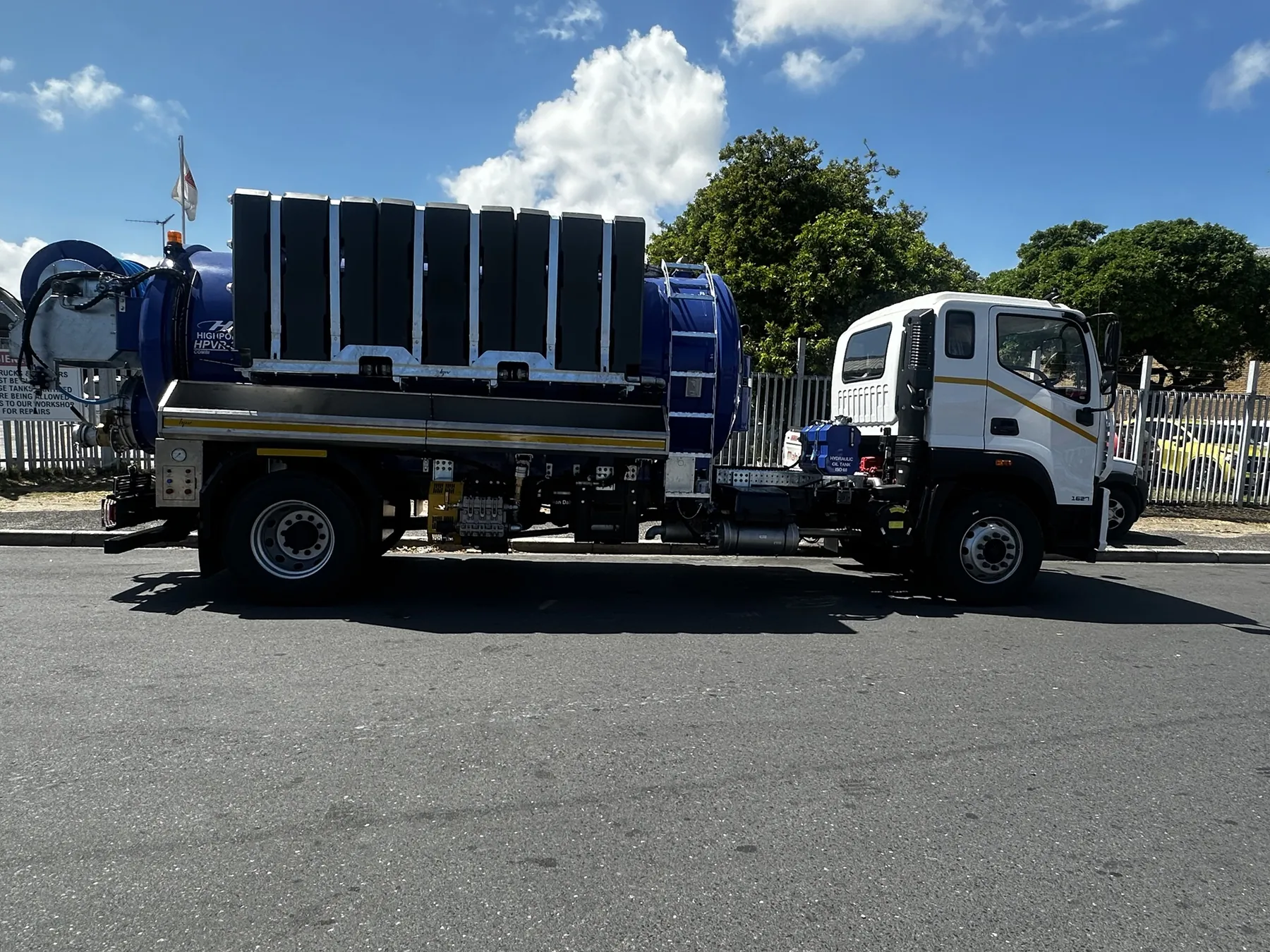 Full-length side view of a combination super sucker with its ladder and hydraulic oil tank